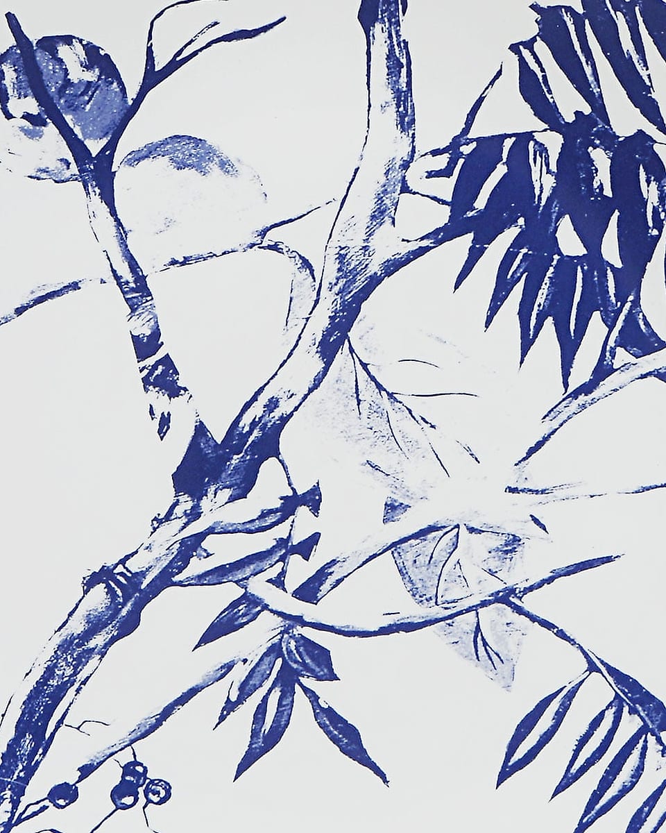A porcelain wall plate with a blue botanical print