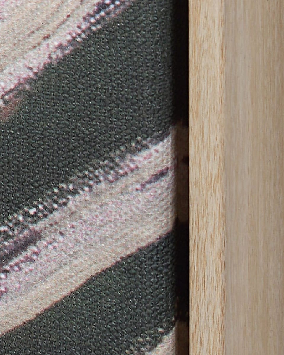 A canvas set in a floating frame, with a gap between canvas and frame