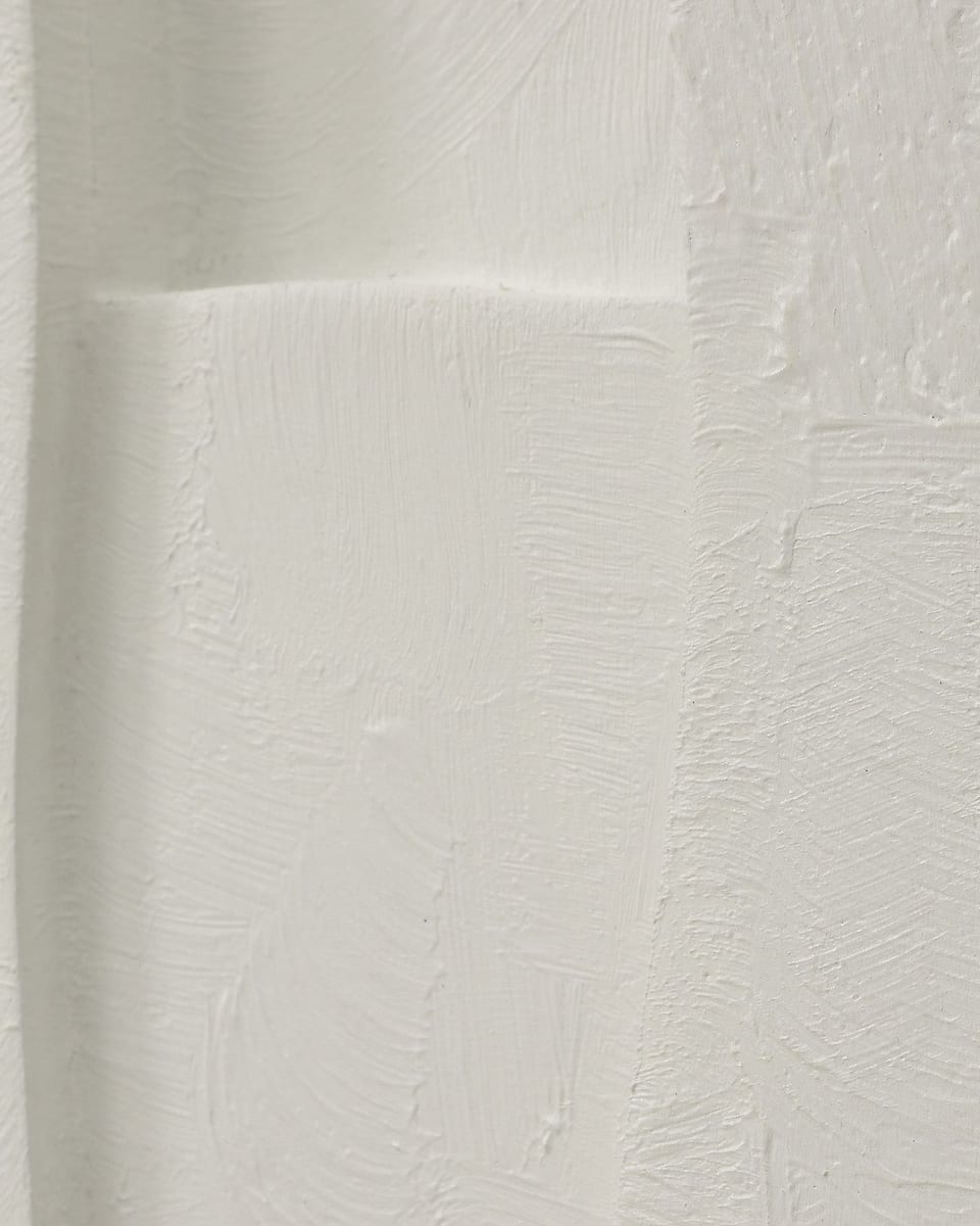 Plaster built up in raised shapes on a relief piece